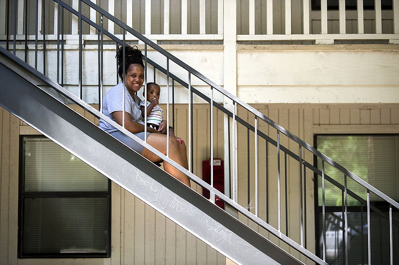 Sahmone Robinson sits with her 1-year-old son, Riley, at their apartment Saturday in Benton. Robinson said she’s struggled to pay her rent during the pandemic and hasn’t had cooperation from the property management company that owns the building in her attempts to obtain emergency renter assistance. Now she’s concerned she”ll be evicted next month.
(Arkansas Democrat-Gazette/Stephen Swofford)