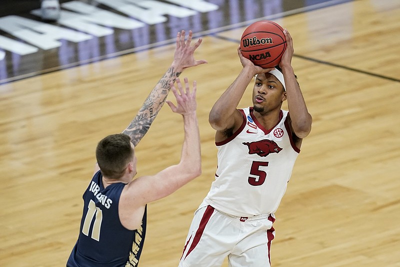 FILE - in this March 27, 2021, file photo, Arkansas guard Moses Moody (5) shoots over Oral Roberts guard Carlos Jurgens (11) during the second half of a Sweet 16 game in the NCAA men's college basketball tournament at Bankers Life Fieldhouse in Indianapolis. Moody played one season at Arkansas and is one of the top shooting guards in the NBA draft. (AP Photo/Darron Cummings, File)