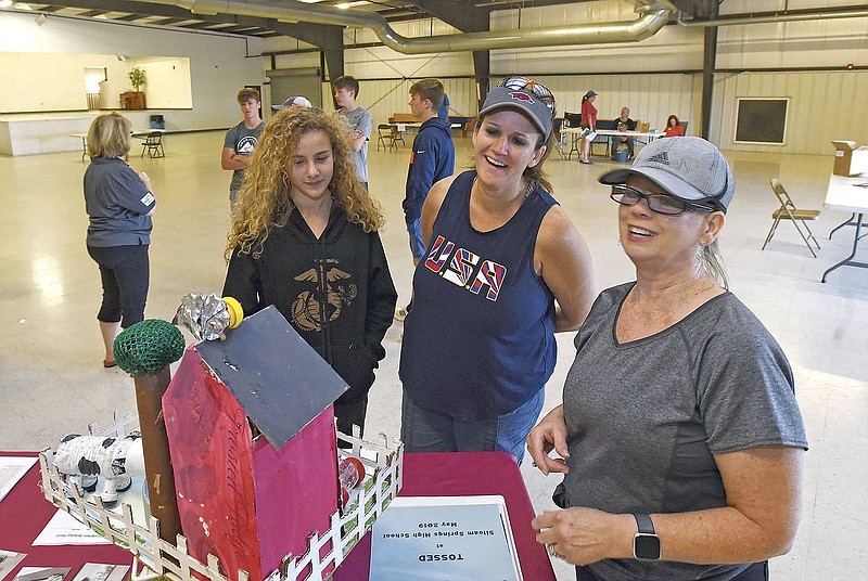 COUNTY FAIR OPEN HOUSE
Riley Wanket (left), a member of Cannonball 4-H in Pea Ridge, and her mom, Angela Wanket (center) hear Saturday July 24 2021 information from Linda Simpson, a Benton County Fair superintendent, about entering the 117th annual Benton County Fair set for Sept. 28-Oct. 2. Extension agents, fair officials and volunteers were on hand during an open house to answer questions and hand out information for people wishing to enter livestock, food, crafts or other goods in the fair. People could also find out about dozens of free classes for youths and adults to help them be successful exhibitors. The fair office will open at the fairgrounds, 7640 S.W. Regional Airport Blvd., Sept. 22-23 for participants to pick up exhibit tags and fair passes. A pre-fair horse show takes place at 9 a.m. Sept. 25. Opening day on Sept. 28 is military, first responder and health care wrokers appreciation day. Go to nwaonline.com/210725Daily/ to see more photos.
(NWA Democrat-Gazette/Flip Putthoff)