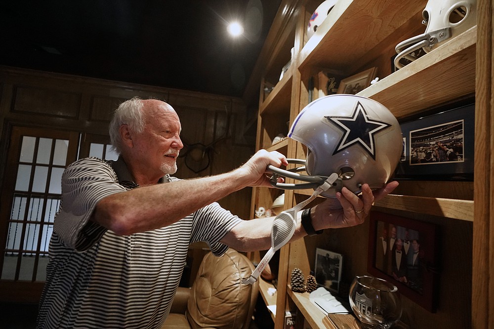 Former Dallas Cowboys and NFL football great Cliff Harris pulls out the helmet he wore during his playing days during an interview at his home in North Dallas, Wednesday, June 30, 2021. Harris and receiver Drew Pearson, who also will be inducted this year as part of the class of 2021, are the first undrafted Cowboys among their 15 players in the Hall of Fame. (AP Photo/LM Otero)