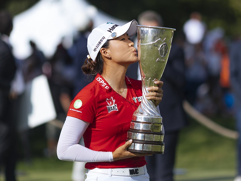 Australia's Minjee Lee kisses the trophy as she poses for photographers after winning the Evian Championship women's golf tournament in Evian, eastern France, Sunday, July 25, 2021. (AP Photo)