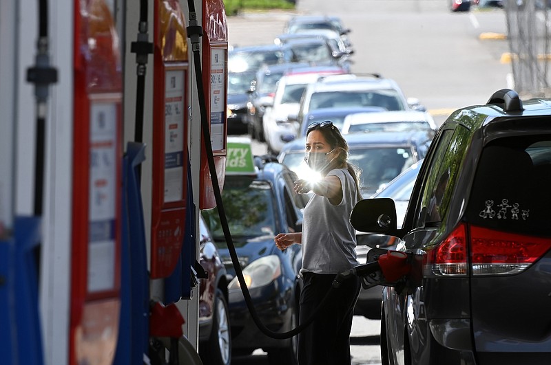 After a cyber hack of the Colonial Pipeline led to gas shortages, people waited in long lines at an Exxon station on May 12, 2021, in Springfield, Va. MUST CREDIT: Washington Post photo by Matt McClain