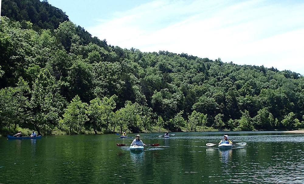 Canoe and kayak paddlers take in the scenery July 2 2021 on the cool White River below Beaver Dam.
(NWA Democrat-Gazette/Flip Putthoff)