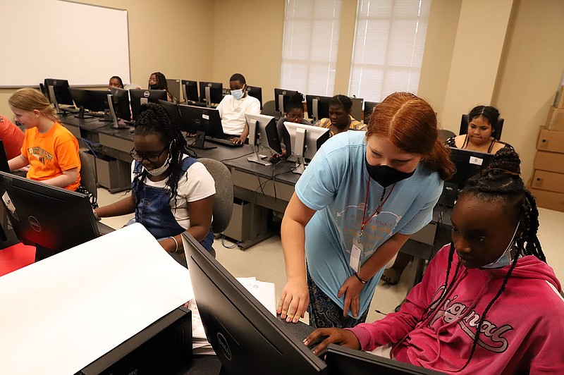 Middle schoolers participate in South Arkansas Community College's Verizon Innovative Learning program, a computer science summer learning course, with the help of program grad Cerenity Brant. (Contributed)