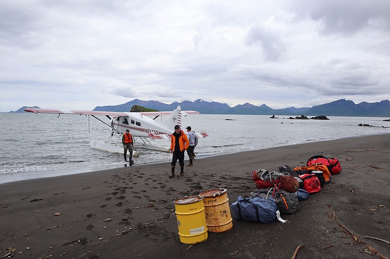A team of scientists unloads food and gear from a floatplane on a beach in the Aniakchak National Monument & Preserve. (The Washington Post/Emily Schwing)