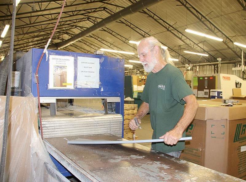 LYNN KUTTER ENTERPRISE-LEADER
Roy Vanwolfe with PolyTech Plastic Molding & Extrusion in Prairie Grove is working with a machine that produces a carton support for Rheem air conditioners.