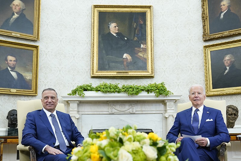 President Joe Biden, right, meets with Iraqi Prime Minister Mustafa al-Kadhimi, left, in the Oval Office of the White House in Washington, Monday, July 26, 2021. (AP Photo/Susan Walsh)