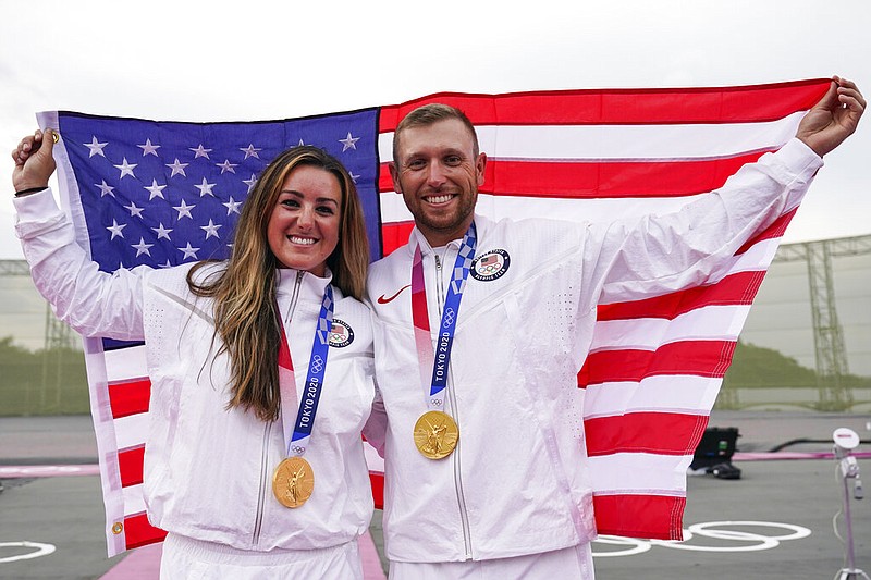 Amber English, left, and Vincent Hancock, both of the United States, celebrate taking the gold medal in the women's and men's skeet Monday at the Asaka Shooting Range in the 2020 Summer Olympics in Tokyo. - Photo by Alex Brandon of The Associated Press