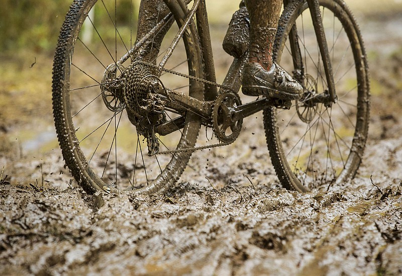 A competitor in the UCI Junior Men race pedals through mud Sunday, Oct. 6, 2019, during the the Fayettecross cyclocross races at Centennial Park at Millsap Mountain in Fayetteville. (NWA Democrat-Gazette/BEN GOFF)