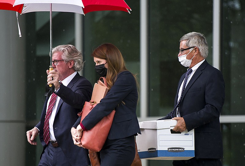 J. Blake Hendrix, left, and Annie Depper walk with Gilbert Baker as they leave the Federal Courthouse after the first day of his trial on Monday, July 26, 2021. Baker is accused of bribing former Circuit Judge Michael Maggio as part of a scheme to get Maggio to lower a financial judgement against Greenbrier Nursing and Rehabilitation Center in the death of patient Martha Bull, according to a 2019 federal indictment. The trial is expected to last as long as three weeks.

(Arkansas Democrat-Gazette/Stephen Swofford)