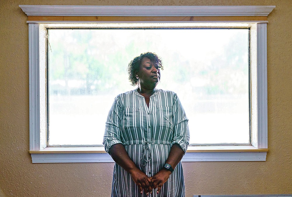 Latonya Crowley, mother of Warren Williams, stands for a portrait in Palatka, Fla., Thursday, April 22, 2021. An FBI probe revealed a murder plot against her son by klansmen working as prison guards where Williams was once an inmate. "In the state of mind that he's in today. I don't see him getting better," Crowley says, as she and her son live today with uncertainty and paranoia. One of the guards' imminent release and the specter of other klansmen have made it impossible for Williams to move on. (AP Photo/David Goldman)
