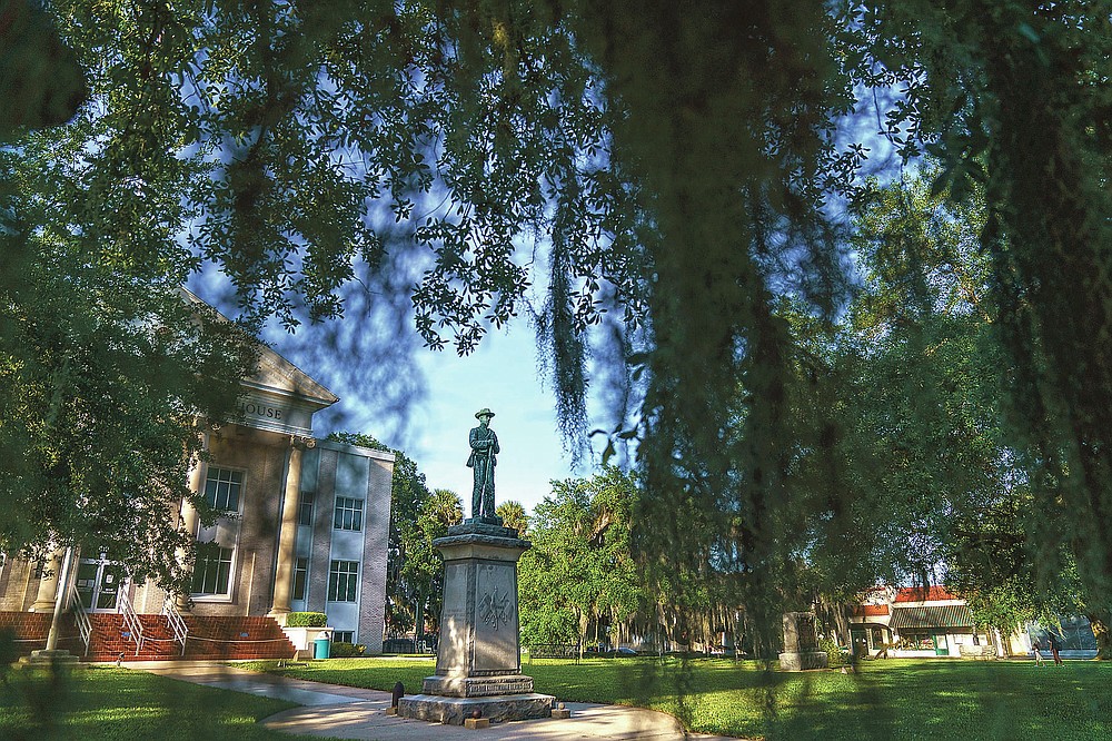A Confederate statue stands outside the Putnam County Courthouse in Palatka, Fla., Tuesday, April 13, 2021. In the 1920s, Jim Crow Florida was one of the most dangerous places in the South to be Black. (AP Photo/David Goldman)