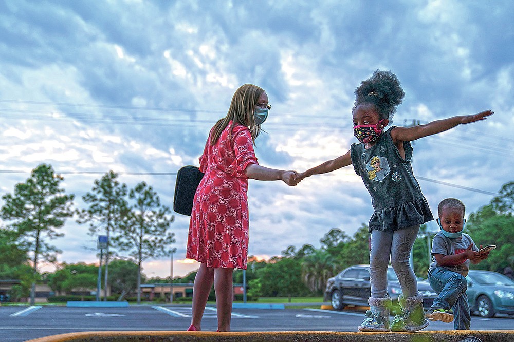 Worshippers leave a church service in Palatka, Fla., Wednesday, April 14, 2021. Palatka, with a population split almost equally between Black and white, had been devastated by the 2008 Great Recession. (AP Photo/David Goldman)