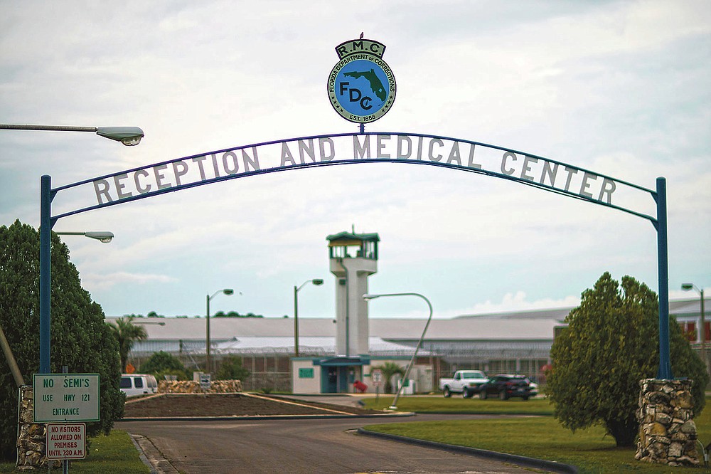 A guard tower stands behind the entrance to the Reception and Medical Center, the state's prison hospital where new inmates are processed, in Lake Butler, Fla., Friday, April 16, 2021. In 2013, at a prison dorm room in the facility, Warren Williams, a Black inmate who suffered from severe anxiety and depression, found himself in front of Thomas Driver, a white prison guard, after he lost his identification badge, a prison infraction. (AP Photo/David Goldman)