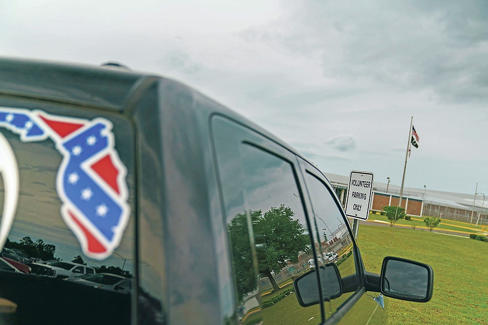 A pickup truck with a Confederate flag-themed decal is parked outside the Reception and Medical Center, the state's prison hospital where new inmates are processed, in Lake Butler, Fla., Friday, April 16, 2021. In 2013, at a prison dorm room in the facility, Warren Williams, a Black inmate who suffered from severe anxiety and depression, found himself in front of Thomas Driver, a white prison guard, after he lost his identification badge, a prison infraction. (AP Photo/David Goldman)