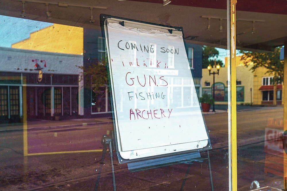 A sign stands in a vacant storefront window in Palatka, Fla., Tuesday, April 13, 2021. The town, with a population split almost equally between Black and white, had been devastated by the 2008 Great Recession. Many of its prized murals were fading, and there were more shuttered shops in the old downtown than open. (AP Photo/David Goldman)