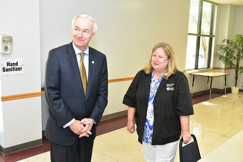 Gov. Asa Hutchinson and Dumas Family Pharmacy owner Cheryl Stimson meet before a community discussion on COVID-19 Tuesday, July 27, at the Dumas Community Center. (Pine Bluff Commercial/I.C. Murrell)