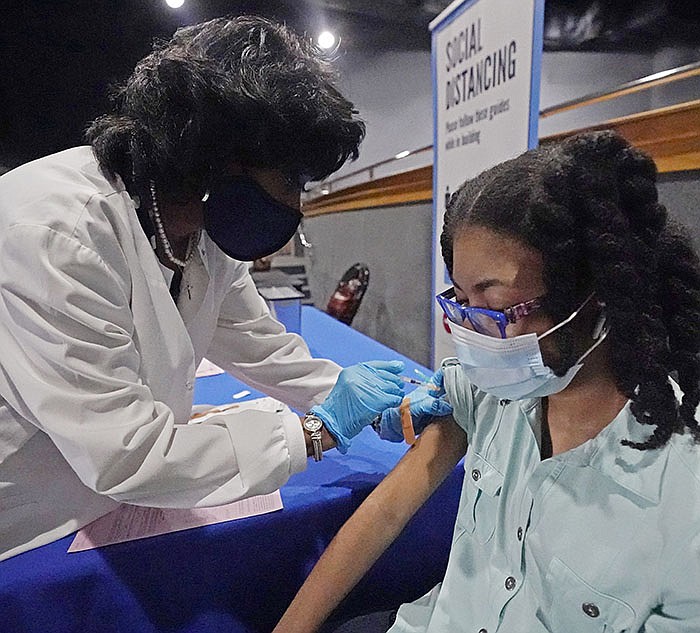 Jackson-Hinds Comprehensive Health Center nurse Maggie Bass gives Ayana Campbell, 14, a shot of the Pfizer vaccine Tuesday at Jackson State University in Jackson, Miss., at a clinic sponsored by the university and the medical center. Vaccines remain remarkably effective against the worst effects of and strain of the coronavirus, officials say.
(AP/Rogelio V. Solis)