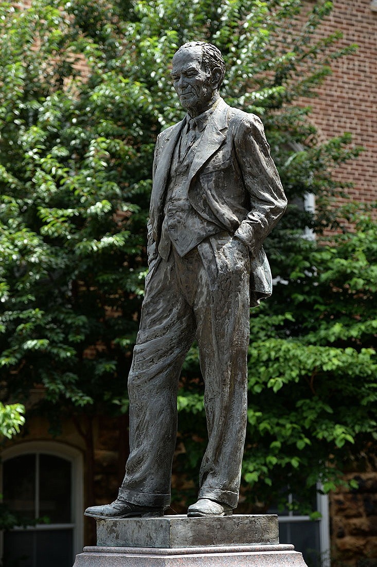 J. William Fulbright’s statue stands near the west entrance of Old Main on the University of Arkansas campus in Fayetteville. The UA Board of Trustees will vote today on whether the statue will remain but added context “that presents the full legacy” of Fulbright.
(NWA Democrat-Gazette/Andy Shupe)