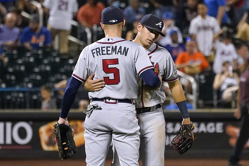 Atlanta Braves' Austin Riley and Freddie Freeman (5) celebrate at the end of the team's baseball game against the New York Mets, Tuesday, July 27, 2021, in New York. The Braves won 12-5. (AP Photo/Mary Altaffer)