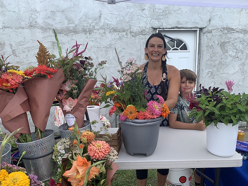 SALLY CARROLL/SPECIAL TO MCDONALD COUNTY PRESS
Jesseca Freese and her son, Niko Freese-Davis, prepare to sell fresh flowers from their farm, Rolling Acres Farm. The flowers often spark conversations and many smiles, Freese said.