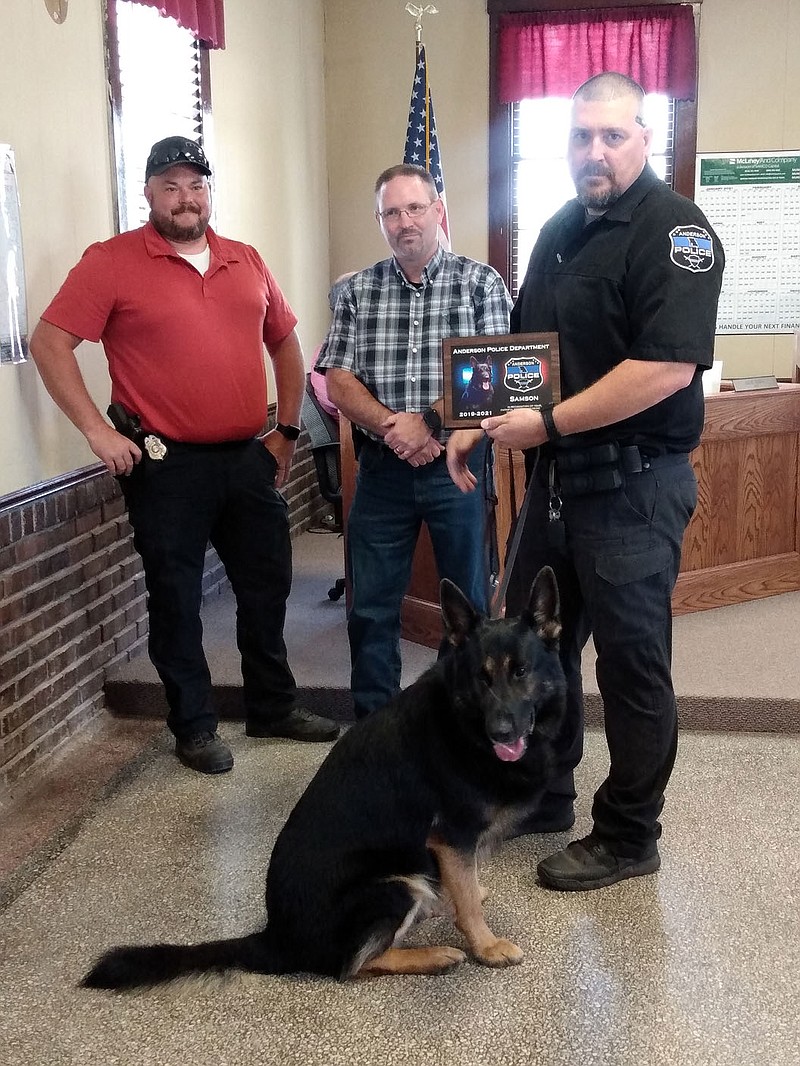 MEGAN DAVIS/MCDONALD COUNTY PRESS Police Chief Dave Abbott and Mayor Rusty Wilson presented K-9 Samson and his partner, Officer Willet, with a plaque in honor of their years served together on the force before Samson's medically-required retirement.