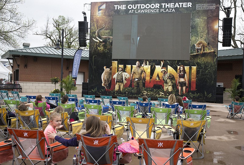 NWA Democrat-Gazette/CHARLIE KAIJO Attendees watch an outdoor screening of Jumanji, Monday, May 4, 2018 at the Bentonville Square in Bentonville.

Food and shopping vendors set up tables at the Square for the Bentonville Film Festival.