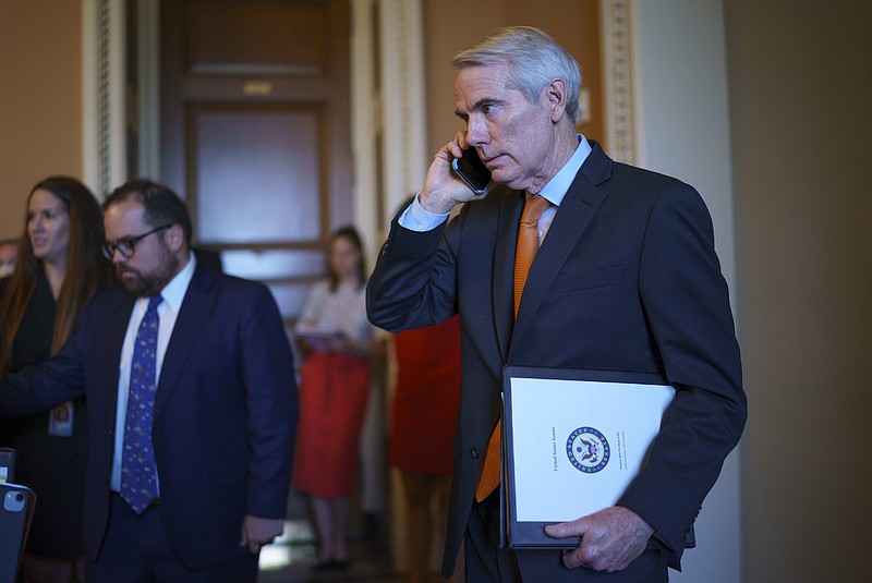 Sen. Rob Portman, R-Ohio, the lead GOP negotiator on the infrastructure talks, emerges from the office of Senate Republican leader Mitch McConnell to announce he has reached a $1 trillion infrastructure bill with Democrats and is ready to vote to take up the bill, at the Capitol in Washington, Wednesday, July 28, 2021. (AP Photo/J. Scott Applewhite)