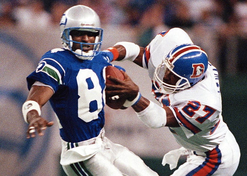 FILE - In this Oct. 23, 1989, file photo, Seattle Seahawks' Louis Clark (84) brings in a pass as Denver Broncos' Steve Atwater defends during an NFL football game in Seattle. Atwater will be inducted into the Pro Football Hall of Fame with the class of 2020. (AP Photo/Barry Sweet, File)