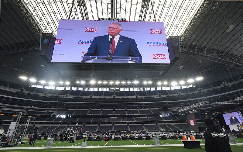Big 12 commissioner Bob Bowlsby is shown on the giant screen as he speaks during NCAA college football Big 12 media days Wednesday, July 14, 2021, in Arlington, Texas. (AP Photo/LM Otero)