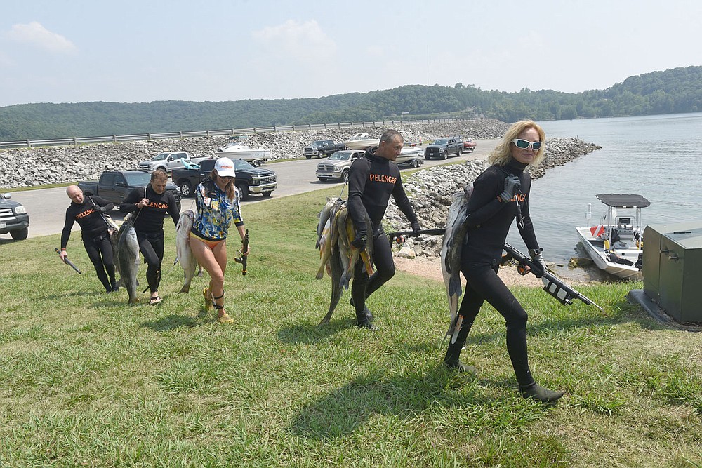 The spearfishing team from Ukraine carries July 22 2021 their fish to the weigh-in.
(NWA Democrat-Gazette/Flip Putthoff)