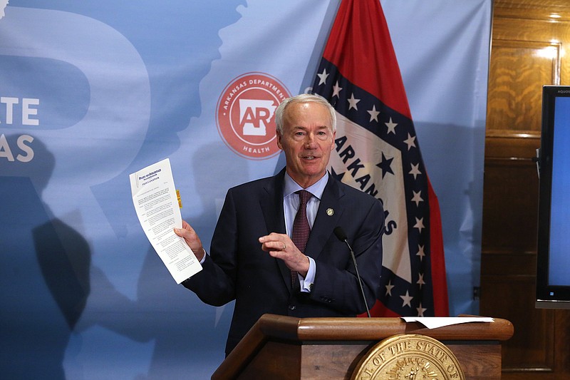 Gov. Asa Hutchinson shows the shows the proclamation reinstating the public health emergency in the state during a press conference on Thursday, July 29, 2021, at the state Capitol in Little Rock. 
More photos at www.arkansasonline.com/730gov/
(Arkansas Democrat-Gazette/Thomas Metthe)