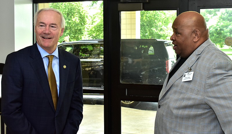 Gov. Asa Hutchinson chats with Dumas School District Superintendent Kelvin Gragg before a community discussion on Tuesday at the Dumas Community Center. (Pine Bluff Commercial/I.C. Murrell)