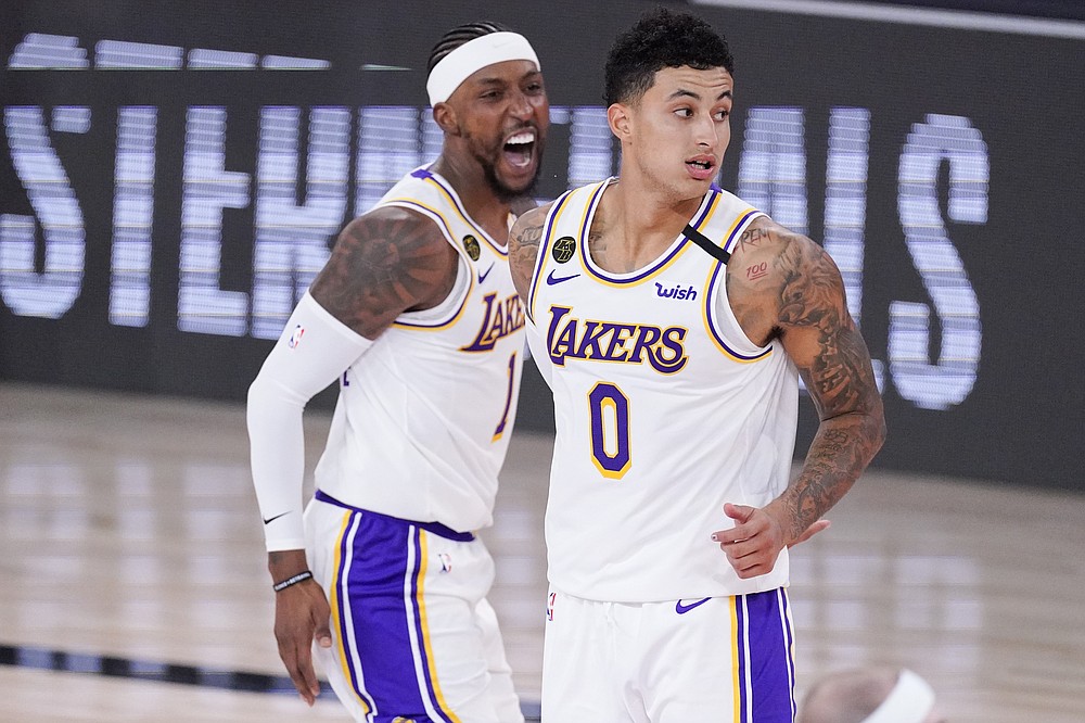 FILE - In this Sept. 12, 2020, file photo, Los Angeles Lakers' Kentavious Caldwell-Pope, left, and Kyle Kuzma celebrate in the closing minutes of the team's win over the Houston Rockets in an NBA conference semifinal playoff basketball game in Lake Buena Vista, Fla. The Lakers are acquiring All-Star point guard Russell Westbrook from the Washington Wizards for three players and this year's first-round draft pick.
According to two people with knowledge of the deal, the Lakers are trading Kuzma, Caldwell-Pope and Montrezl Harrell to Washington for Westbrook. (AP Photo/Mark J. Terrill, File)