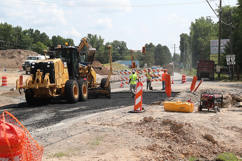 A construction crew works on the roundabout that will connect highways 5 and 7 to the 5.82-mile extension of the King Expressway. - Photo by Richard Rasmussen of The Sentinel-Record