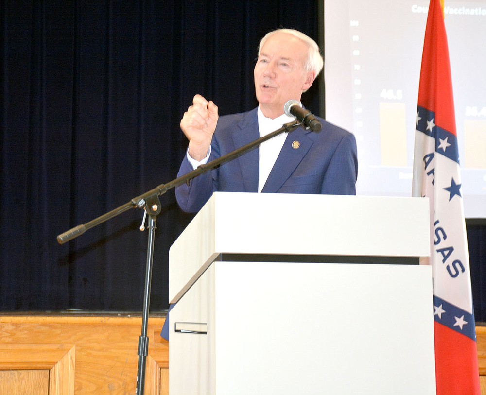 Marc Hayot/Siloam Sunday Governor Asa Hutchinson addresses a local resident's concerns related to the coronavirus vaccine during his Covid Conversation held at 11 a.m. on Friday at the Siloam Springs Community Building. Several members of the audience voiced their objections to the vaccine and the possibility of a new mask mandate during the governor's talk.