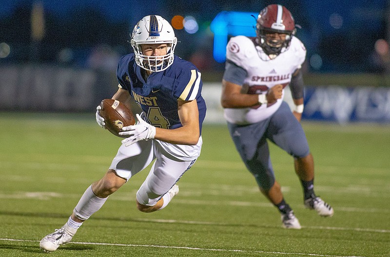 Ty Durham (14) of Bentonville West runs with the ball after a catch during an Oct. 2 game against Springdale at Wolverine Stadium in Centerton. The Wolverines are ready to start a new season when they hit the practice field Monday afternoon. / Special to NWA Democrat-Gazette/ David Beach