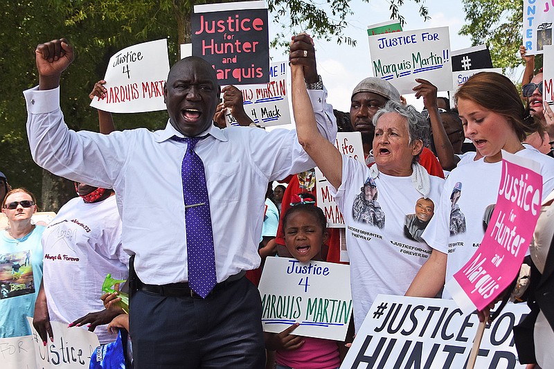Attorney Benjamin Crump (left) holds hands with Rebecca Payne, Hunter Brittain‚Äôs grandmother, as they chant during a rally Friday, July 30, 2021 in front of the State Capitol building in Little Rock.
(Arkansas Democrat-Gazette/Staci Vandagriff)
