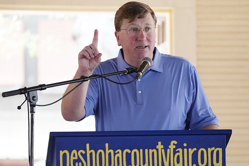 Republican Gov. Tate Reeves tells fairgoers of that he will seek additional funds for public school teachers salaries at the Neshoba County Fair in Philadelphia, Miss., Thursday, July 29, 2021. The fair, also known as Mississippi's Giant House Party, is an annual event of agricultural, political, and social entertainment at what might be the country's largest campground fair. (AP Photo/Rogelio V. Solis)