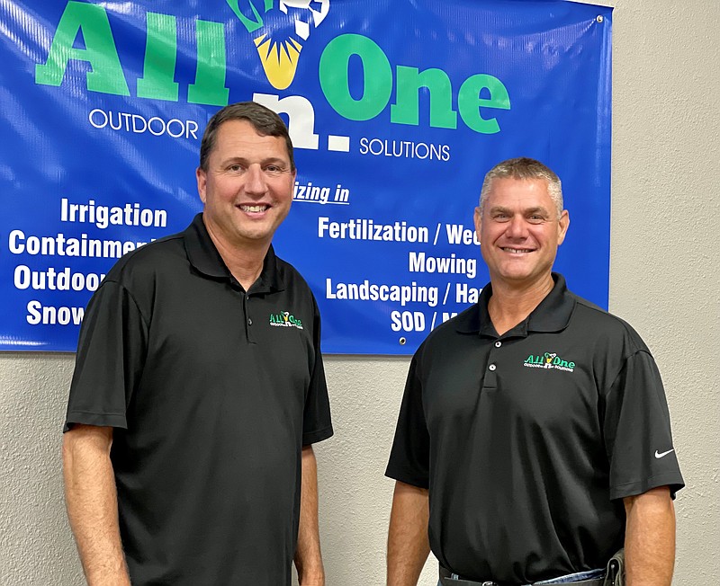 Craig Rehagen, right, owner of A Greener Tomorrow Landscaping, stands with Chris Jordan, president of All-n-One Outdoor Solutions, which recently acquired the local landscaping company. Photo provided
