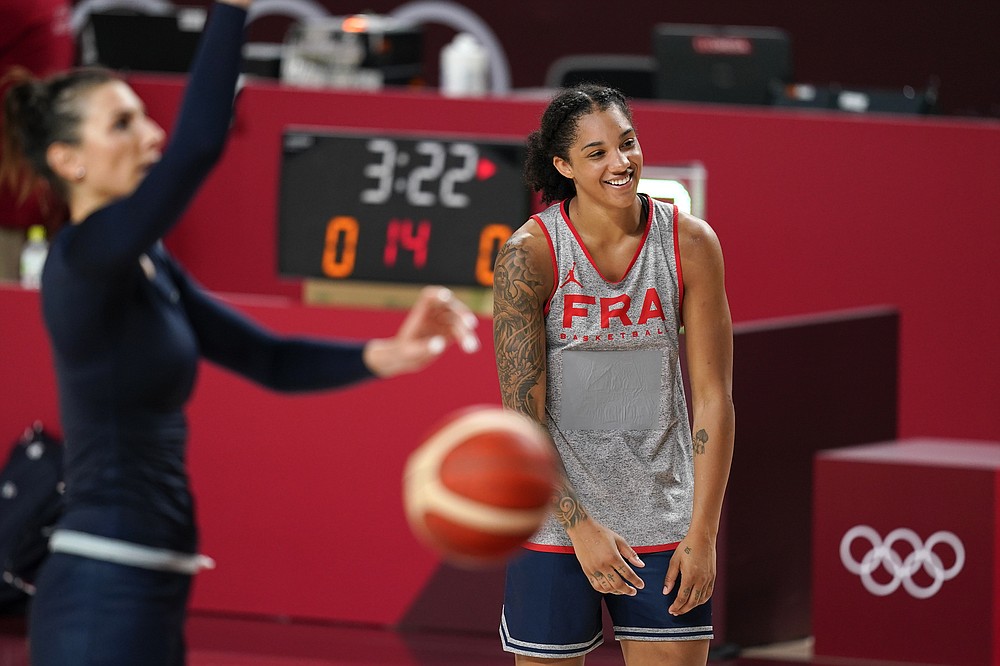 France's Gabby Williams laughs with teammates during a women's basketball practice at the 2020 Summer Olympics, Saturday, July 24, 2021, in Saitama, Japan. (AP Photo/Charlie Neibergall)