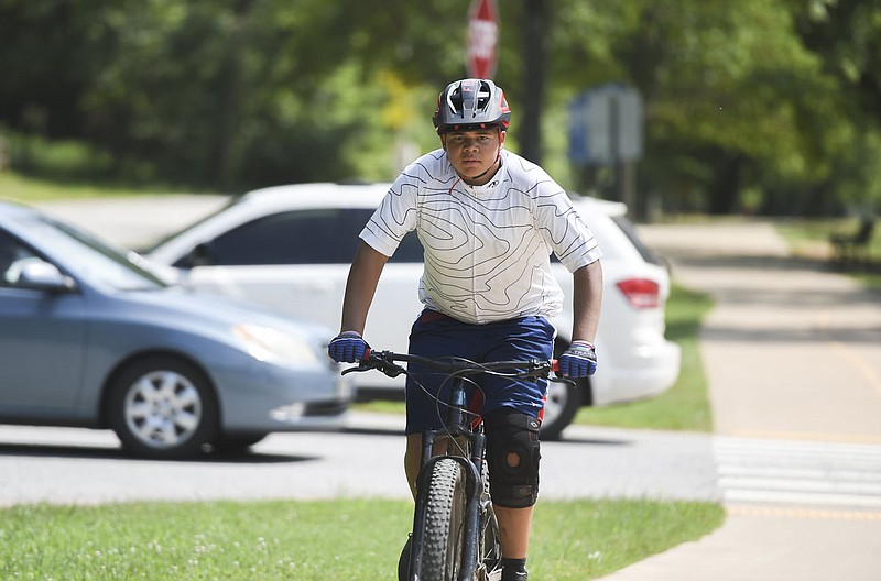 Nate Valentine of Bentonville rides, Friday, July 30, 2021 along the Greenway at the North Bentonville Trail in Bentonville. Regional planners are starting the process of updating the region's Bicycle and Pedestrian Master Plan, which is expected to take about a year. The Regional Bike-Ped Plan sets up an overall vision for a bicycle and pedestrian network in Northwest Arkansas. Check out nwaonline.com/210731Daily/ for today's photo gallery. 
(NWA Democrat-Gazette/Charlie Kaijo)