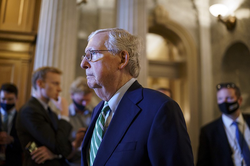 Senate Minority Leader Mitch McConnell, R-Ky., walks past the chamber as the Senate advances to formally begin debate on a roughly $1 trillion infrastructure plan, a process that could take several days, at the Capitol in Washington, Friday, July 30, 2021. (AP Photo/J. Scott Applewhite)