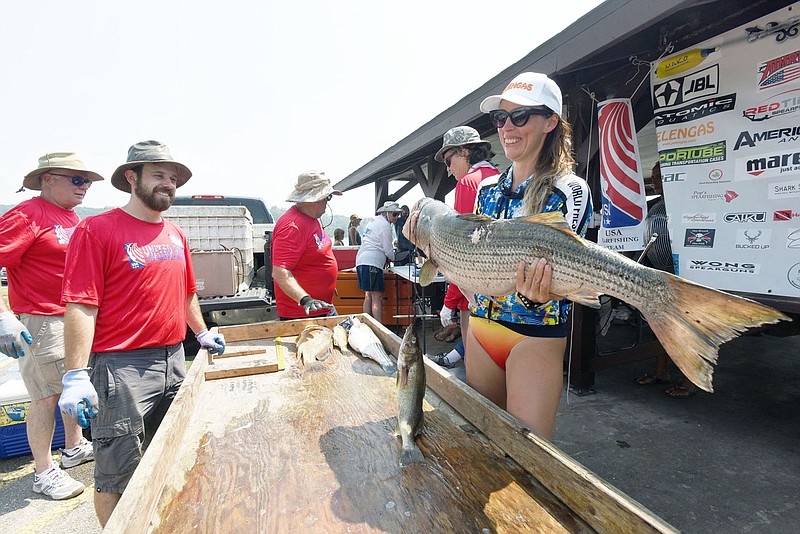 Anzhela Holovianko, a diver from Ukraine, shows a heavy striped bass she shot July 22 2021 at Beaver Lake during the World Freshwater Spearfishing Championship. Forty-four free divers (without the aid of scuba tanks) from eight countries took part in the contest. Some can stay underwater as long as five minutes.