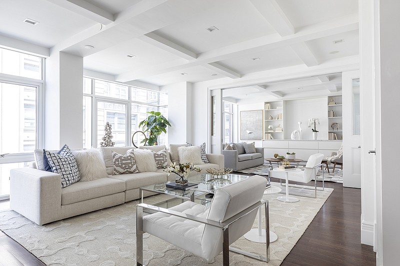 An oversized neutral sofa helps to add an expansive seating area in this narrow living space. (TNS/Handout)