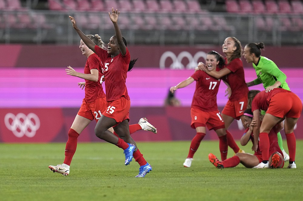 Canada's players celebrate after winning 1-0 to United States during a women's semifinal soccer match at the 2020 Summer Olympics, Monday, Aug. 2, 2021, in Kashima, Japan. (AP Photo/Fernando Vergara)