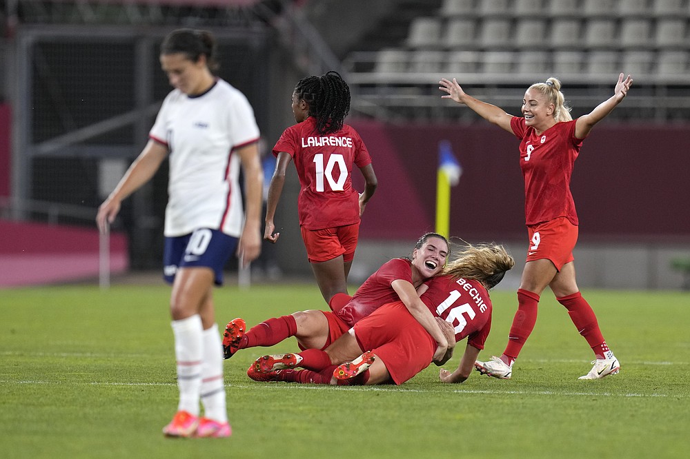 Canada's players celebrate after winning 1-0 to United States during a women's semifinal soccer match at the 2020 Summer Olympics, Monday, Aug. 2, 2021, in Kashima, Japan. (AP Photo/Fernando Vergara)