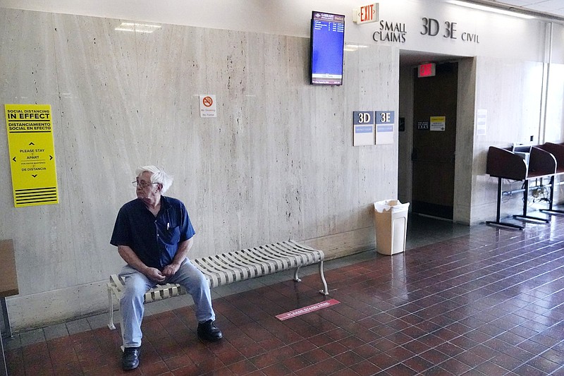 Landlord Gabe Imondi waits for proceedings to start outside an eviction hearing courtroom, Monday, Aug. 2, 2021, in Providence. Rhode Island tenants facing eviction after the lifting of a federal moratorium on being ousted for unpaid rent plead their case in court. Imondi estimates he's out nearly $20,000 from renters who did not pay their rents since September. (AP Photo/Charles Krupa)