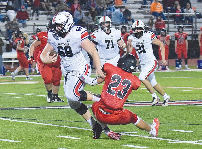 RICK PECK/FILE PHOTO
McDonald County defensive lineman Garreett GrickS (68) gets tripped up by West Plains' Heston Miller (23) after intercepting a deflected pass during the Zizzers' 35-2 win on Nov. 6 in the Missouri Class 4 District 5 semifinals at West Plains High School.