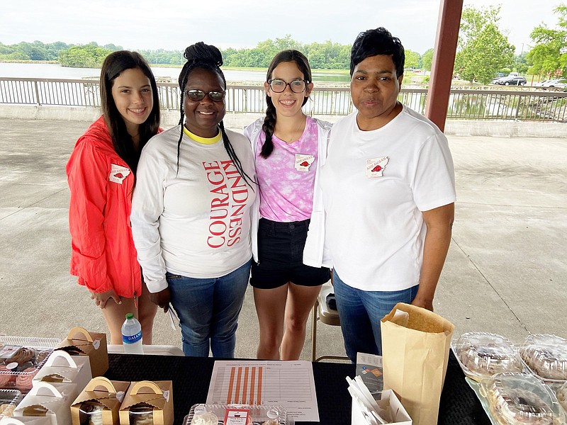 New Horizons Extension Homemakers Club members work to raise money during the grand opening of the Saracen Landing Farmers Market. From left, they are, Sarah Gwin of White Hall, Kimberly Edwards of Redfield, Sophia Gwin of White Hall and Dot Dunn Hart, the new Delta District director for the Arkansas Extension Homemakers Council. (Special to The Commercial/Deborah Horn)